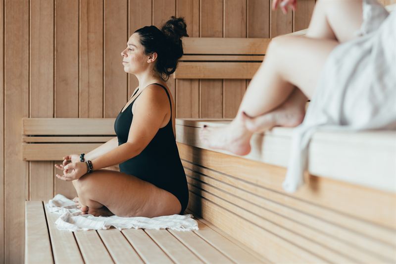 A participant relaxing in a wooden sauna