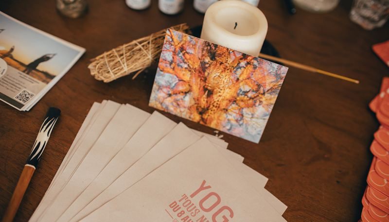 The retreat’s pink programme leaflets, on a table with a candle